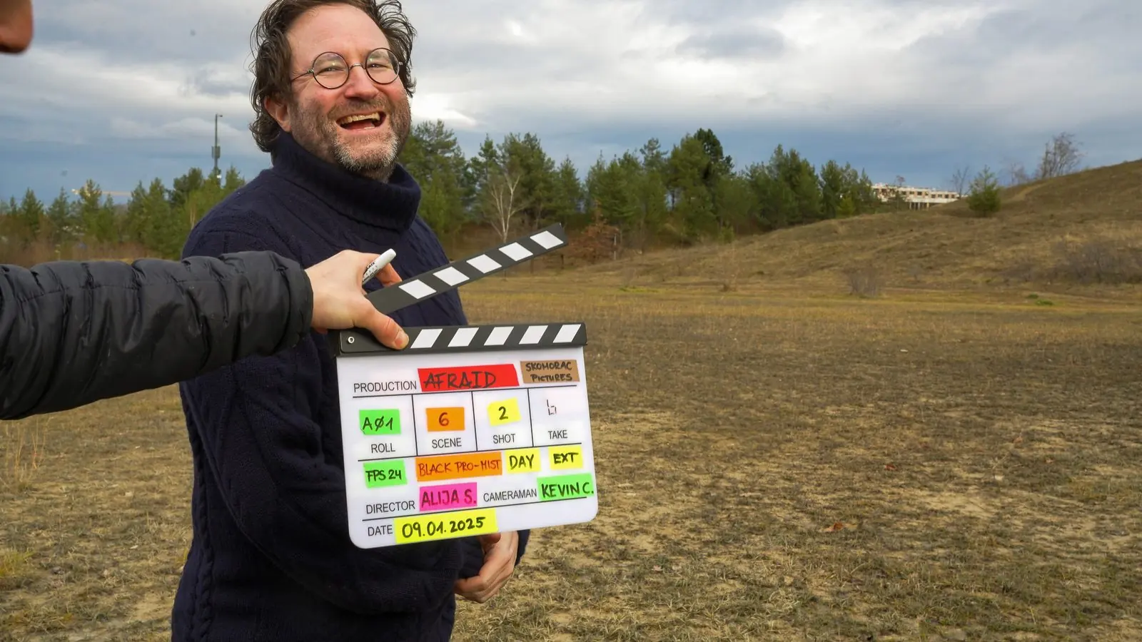 Slating a take with a grin